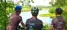 three cyclists look over the grand river