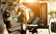 close up of a film camera with the sun in the background